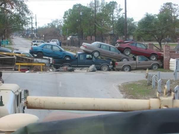 Picture taken by me in 2005 , cars stacked on top of each other. disaster junk clean up is something that needs to be done on the road to recovery.