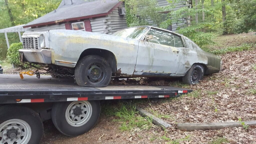 junk car being towed away